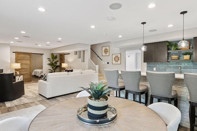 3027 135th Ave NE, Ham Lake, MN 55304 - dining area featuring light wood-style floors, stairway, and recessed lighting