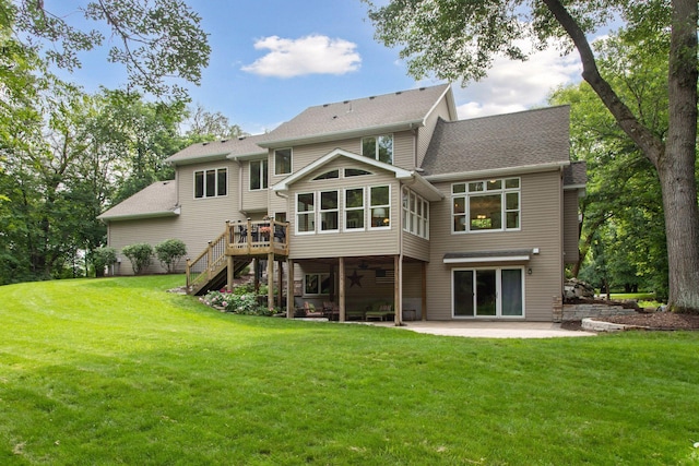 3027 135th Ave NE, Ham Lake, MN 55304 - back of property featuring a patio area, stairway, a wooden deck, a yard, and a shingled roof