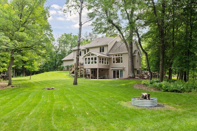 3027 135th Ave NE, Ham Lake, MN 55304 - rear view of house featuring stairs, a wooden deck, a yard, and a sunroom