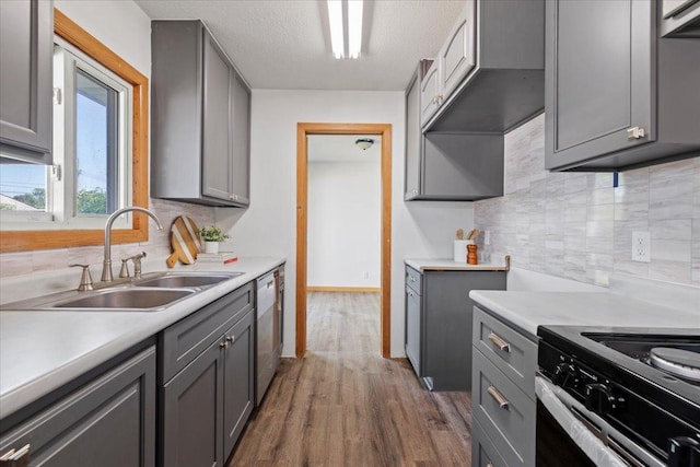 5738 Yates Ave N, Crystal, MN 55429 - kitchen with gray cabinets, stainless steel appliances, tasteful backsplash, light countertops, and a textured ceiling