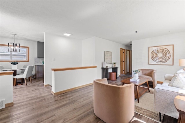 5738 Yates Ave N, Crystal, MN 55429 - living room featuring wood finished floors and a chandelier