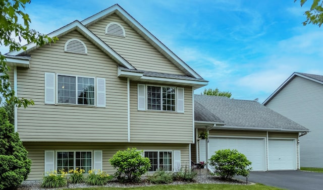 708 12th St, Farmington, MN 55024 - view of front of home with an attached garage, asphalt driveway, and a shingled roof