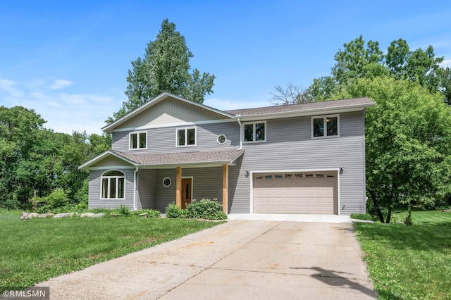 2117 Oakridge St, Saint Paul, MN 55119 - view of front facade with concrete driveway, a front yard, a garage, and covered porch