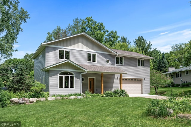 2117 Oakridge St, Saint Paul, MN 55119 - traditional-style home with a garage, a front yard, roof with shingles, and concrete driveway