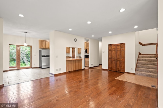 2117 Oakridge St, Saint Paul, MN 55119 - unfurnished living room with wood-type flooring, recessed lighting, and stairway
