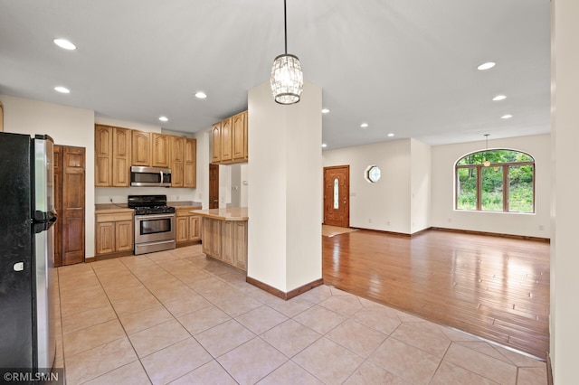 2117 Oakridge St, Saint Paul, MN 55119 - kitchen with appliances with stainless steel finishes, light tile patterned floors, light countertops, recessed lighting, and open floor plan