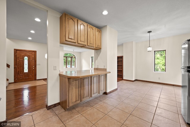 2117 Oakridge St, Saint Paul, MN 55119 - kitchen with plenty of natural light, light tile patterned floors, recessed lighting, freestanding refrigerator, and hanging light fixtures
