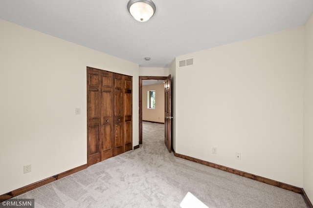 2117 Oakridge St, Saint Paul, MN 55119 - unfurnished bedroom featuring light colored carpet and a closet