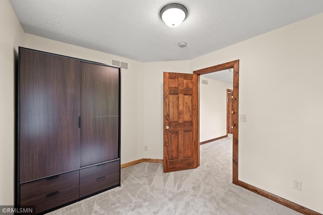2117 Oakridge St, Saint Paul, MN 55119 - unfurnished bedroom with light colored carpet and a textured ceiling