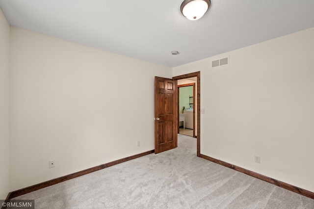 2117 Oakridge St, Saint Paul, MN 55119 - empty room featuring light colored carpet and washer / clothes dryer