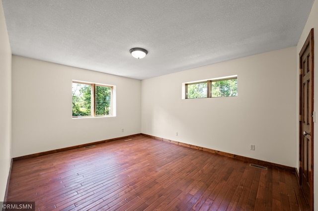 2117 Oakridge St, Saint Paul, MN 55119 - spare room featuring healthy amount of natural light, wood-type flooring, and a textured ceiling