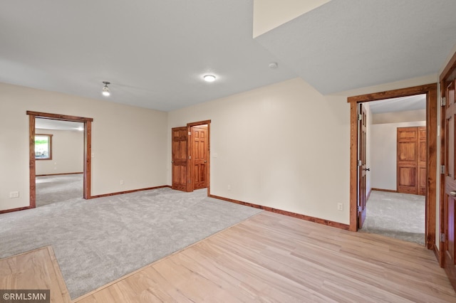 2117 Oakridge St, Saint Paul, MN 55119 - spare room with light wood-style flooring, light carpet, and a smoke detector