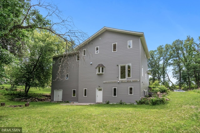 2117 Oakridge St, Saint Paul, MN 55119 - back of house featuring a lawn and a patio