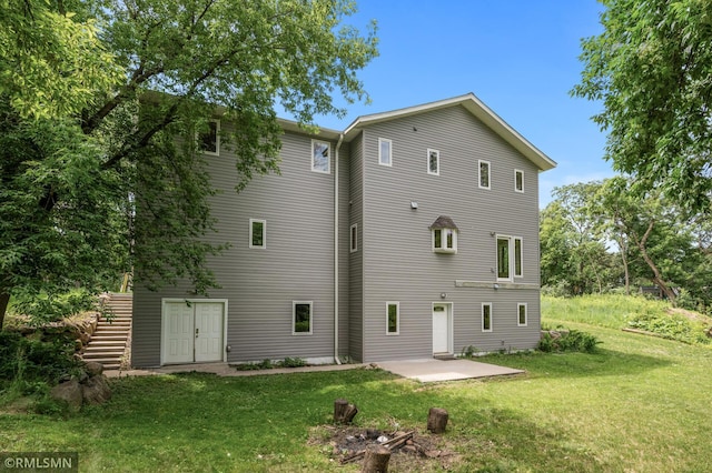 2117 Oakridge St, Saint Paul, MN 55119 - rear view of house featuring a lawn and a patio area
