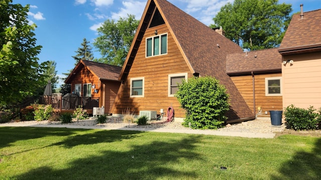 511 4th St W, Jasper, MN 56144 - back of house with a deck, a lawn, and a shingled roof