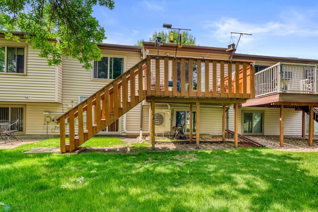 2744 32nd St S, Moorhead, MN 56560 - rear view of house featuring a deck, a lawn, and stairs