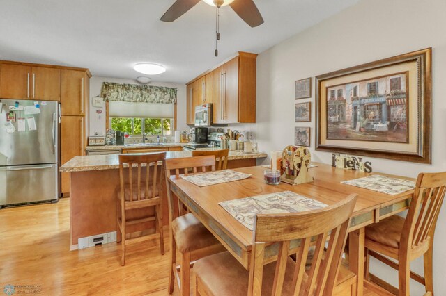 2744 32nd St S, Moorhead, MN 56560 - dining area with light wood-style flooring and a ceiling fan
