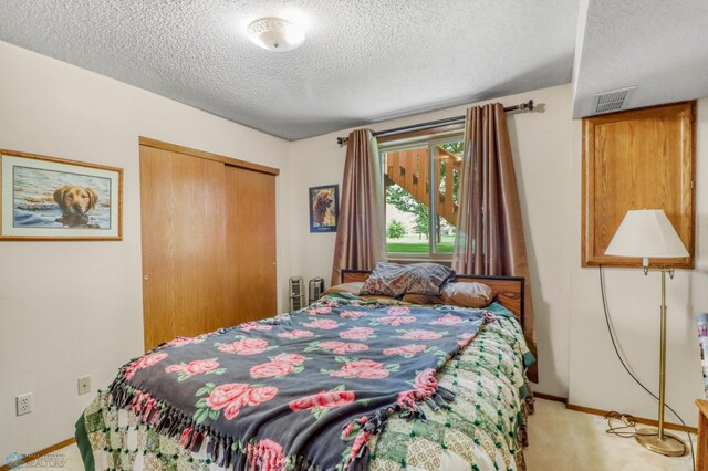 2744 32nd St S, Moorhead, MN 56560 - bedroom featuring light colored carpet, a textured ceiling, and a closet