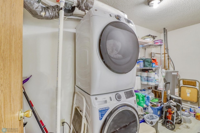2744 32nd St S, Moorhead, MN 56560 - laundry room with stacked washer and clothes dryer and a textured ceiling