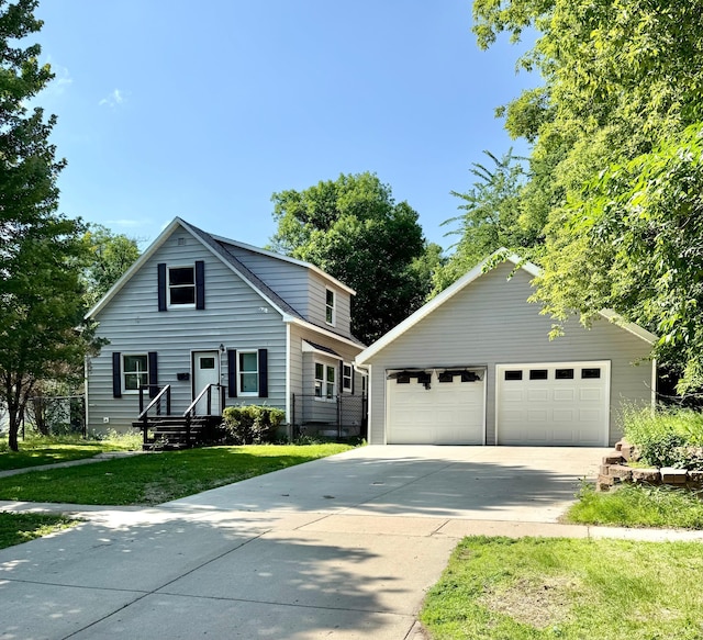 1212 Gorton Ave NW, Willmar, MN 56201 - view of front of home featuring a detached garage, an outdoor structure, and a front lawn