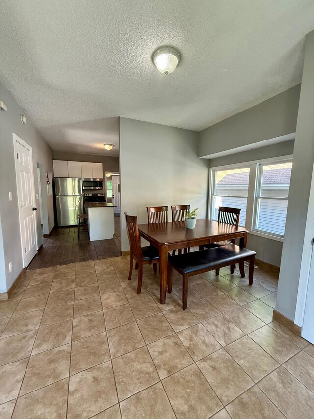 1212 Gorton Ave NW, Willmar, MN 56201 - dining space with a textured ceiling and light tile patterned flooring