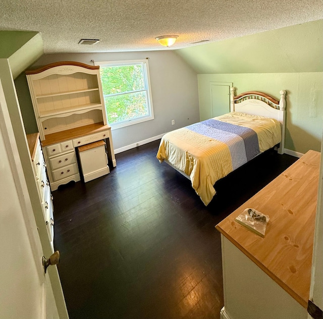 1212 Gorton Ave NW, Willmar, MN 56201 - bedroom with lofted ceiling, a textured ceiling, and dark wood-style floors