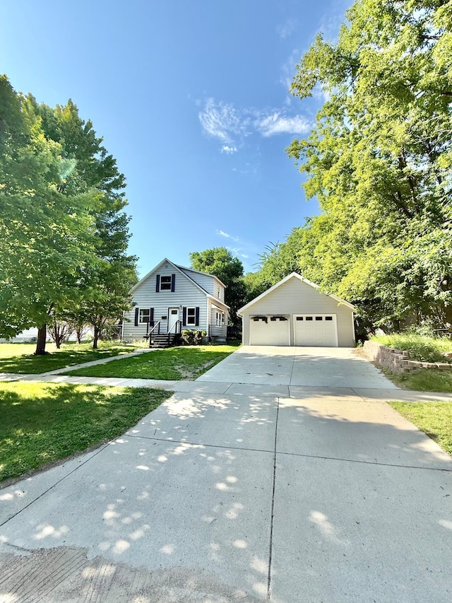 1212 Gorton Ave NW, Willmar, MN 56201 - view of front facade with an outdoor structure, a garage, and a front lawn