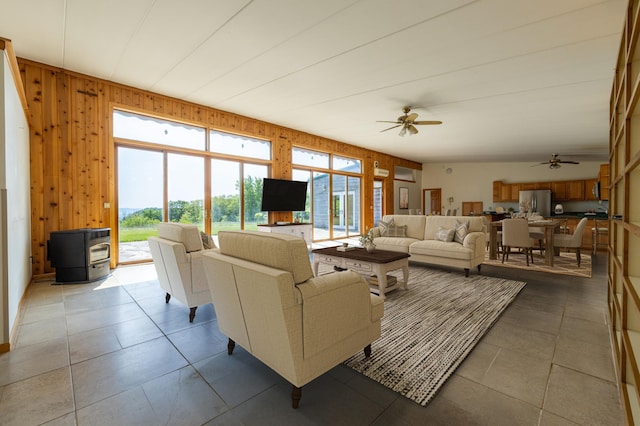 21555 699th St, Wabasha, MN 55981 - tiled living room with a wood stove, a ceiling fan, and wooden walls