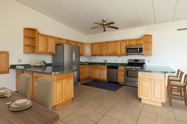21555 699th St, Wabasha, MN 55981 - kitchen featuring open shelves, appliances with stainless steel finishes, a peninsula, dark countertops, and lofted ceiling