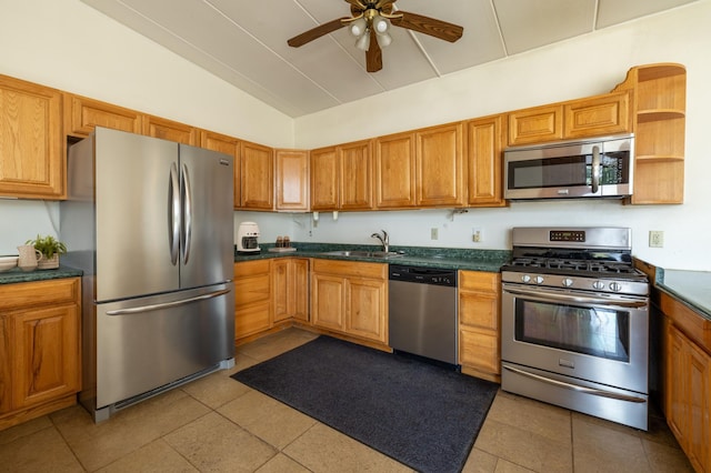 21555 699th St, Wabasha, MN 55981 - kitchen with appliances with stainless steel finishes, lofted ceiling, a ceiling fan, dark countertops, and tile patterned floors