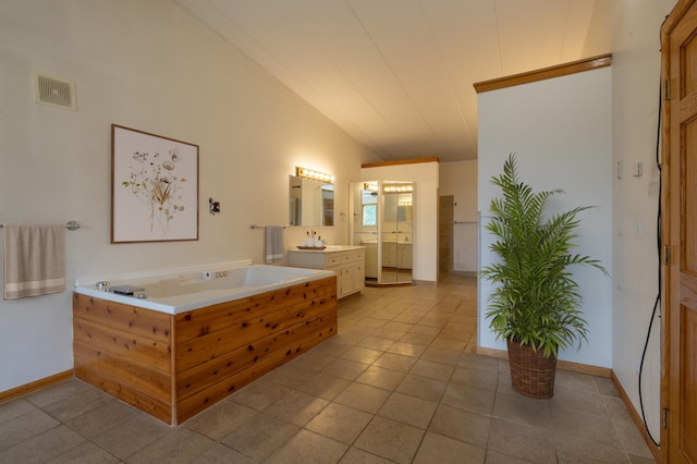 21555 699th St, Wabasha, MN 55981 - bathroom featuring vaulted ceiling, vanity, a garden tub, and tile patterned floors