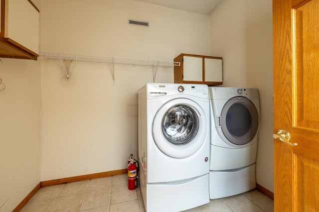 21555 699th St, Wabasha, MN 55981 - washroom with cabinet space, washer and dryer, and light tile patterned floors