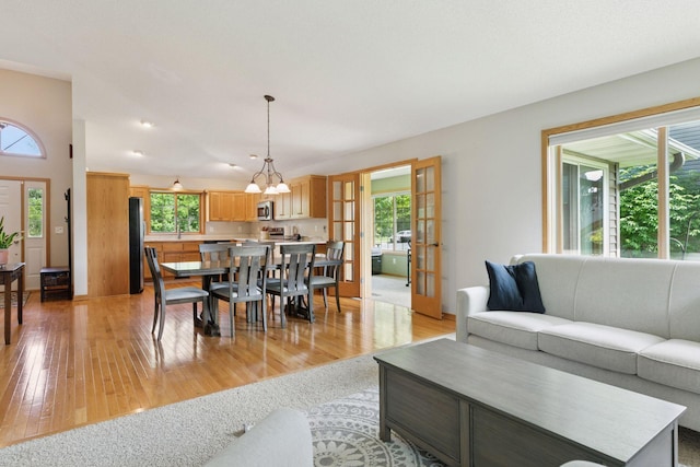 15450 Goodview Ave N, Hugo, MN 55038 - living area with a chandelier and light wood-style floors