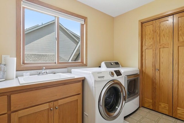15450 Goodview Ave N, Hugo, MN 55038 - laundry room with washer and dryer, cabinet space, and light flooring