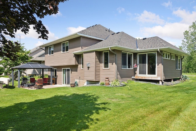 15450 Goodview Ave N, Hugo, MN 55038 - rear view of property featuring a gazebo, a patio, a shingled roof, and a lawn