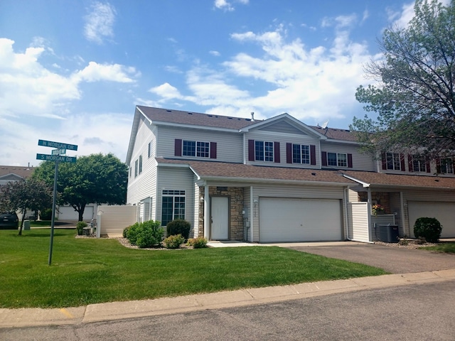 21196 Morgan Dr, Forest Lake, MN 55025 - view of front of home with asphalt driveway, a garage, and a front lawn