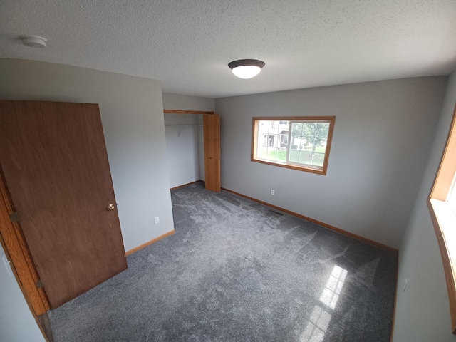 21196 Morgan Dr, Forest Lake, MN 55025 - unfurnished bedroom with carpet floors, a textured ceiling, and a closet