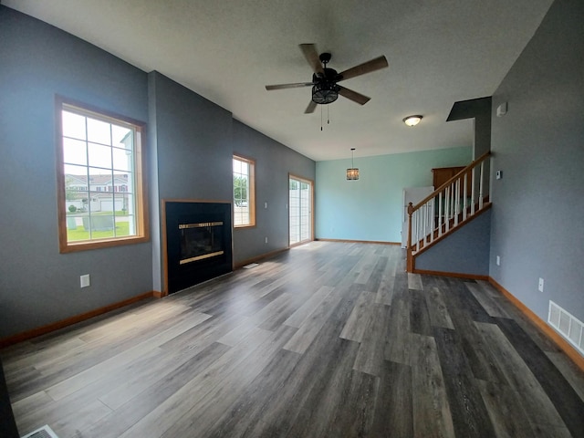 21196 Morgan Dr, Forest Lake, MN 55025 - unfurnished living room with a glass covered fireplace, stairway, wood finished floors, and ceiling fan