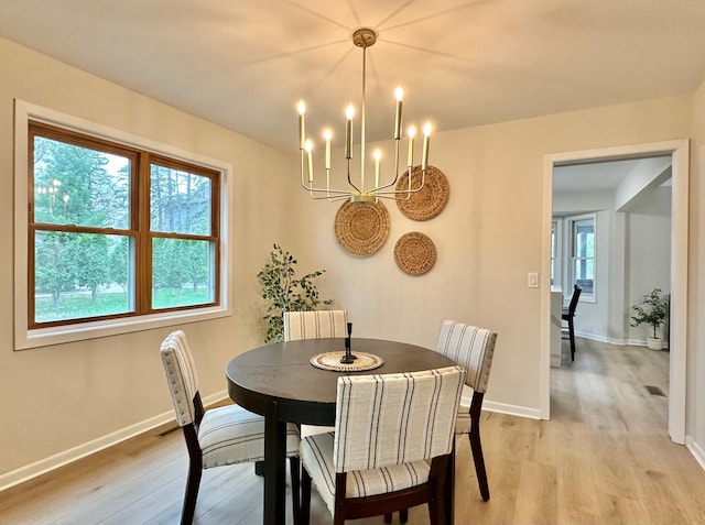 809 Wagon Wheel Trl, Mendota Heights, MN 55120 - dining room featuring light wood-style flooring and a chandelier