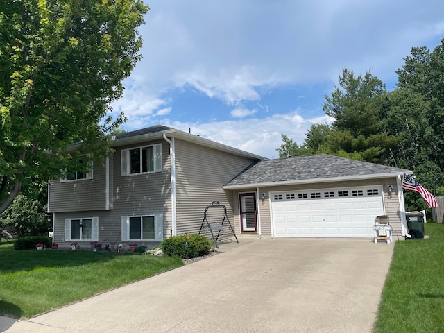 640 Meadowlark Ln, Eden Valley, MN 55329 - split level home featuring a garage, a front lawn, and driveway