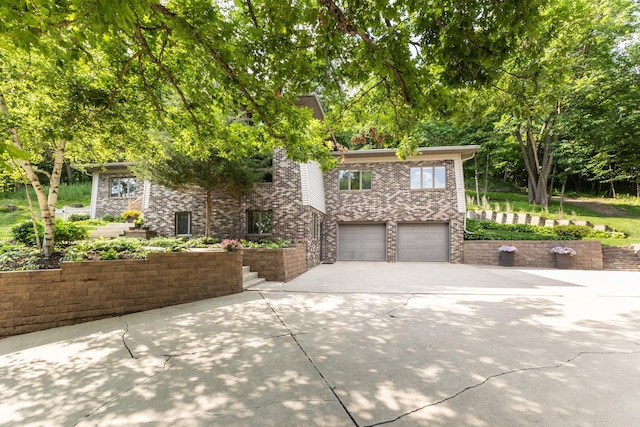 6317 Oak Meadow Ln NW, Rochester, MN 55901 - view of front facade with concrete driveway, an attached garage, and brick siding