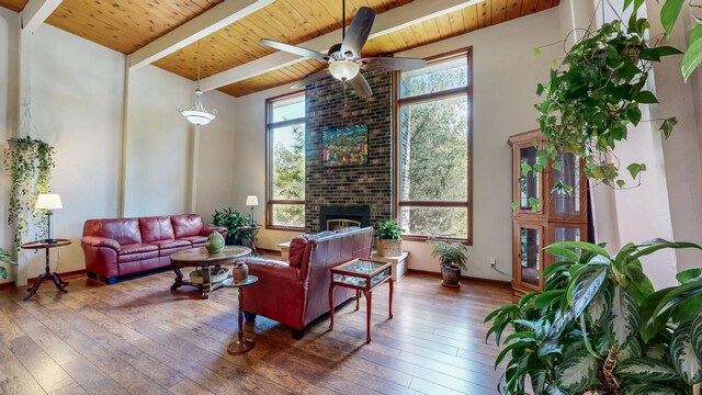 6317 Oak Meadow Ln NW, Rochester, MN 55901 - living area with a wood ceiling with exposed beams, a ceiling fan, hardwood / wood-style floors, and a fireplace
