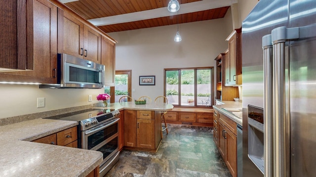 6317 Oak Meadow Ln NW, Rochester, MN 55901 - kitchen featuring stainless steel appliances, a peninsula, a wooden ceiling with exposed beams, stone finish flooring, and brown cabinetry