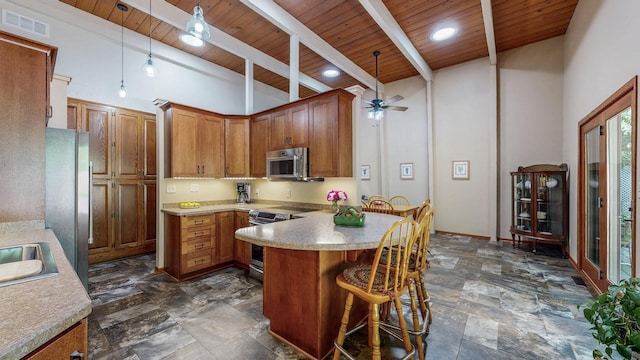 6317 Oak Meadow Ln NW, Rochester, MN 55901 - kitchen featuring appliances with stainless steel finishes, wood ceiling, a peninsula, ceiling fan, and brown cabinets