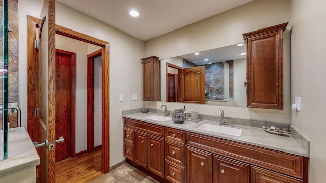 6317 Oak Meadow Ln NW, Rochester, MN 55901 - bathroom with double vanity, wood finished floors, and recessed lighting