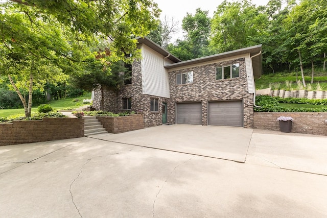 6317 Oak Meadow Ln NW, Rochester, MN 55901 - view of front of house with driveway, a garage, and brick siding