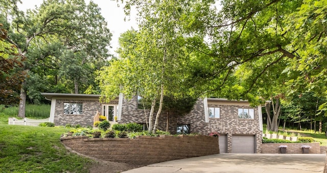 6317 Oak Meadow Ln NW, Rochester, MN 55901 - view of front facade with concrete driveway, an attached garage, brick siding, and a front yard