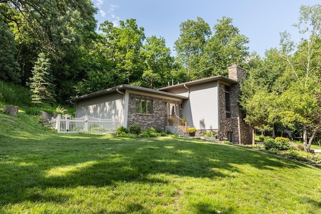 6317 Oak Meadow Ln NW, Rochester, MN 55901 - view of side of home featuring a chimney