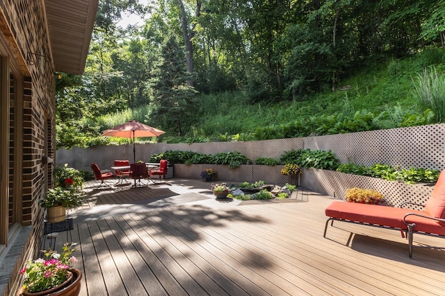 6317 Oak Meadow Ln NW, Rochester, MN 55901 - wooden deck with a fenced backyard and outdoor dining area