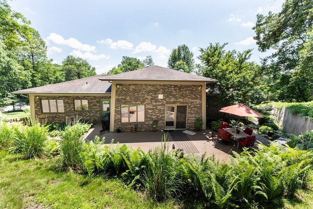 6317 Oak Meadow Ln NW, Rochester, MN 55901 - rear view of house with a wooden deck, brick siding, a shingled roof, and outdoor dining space